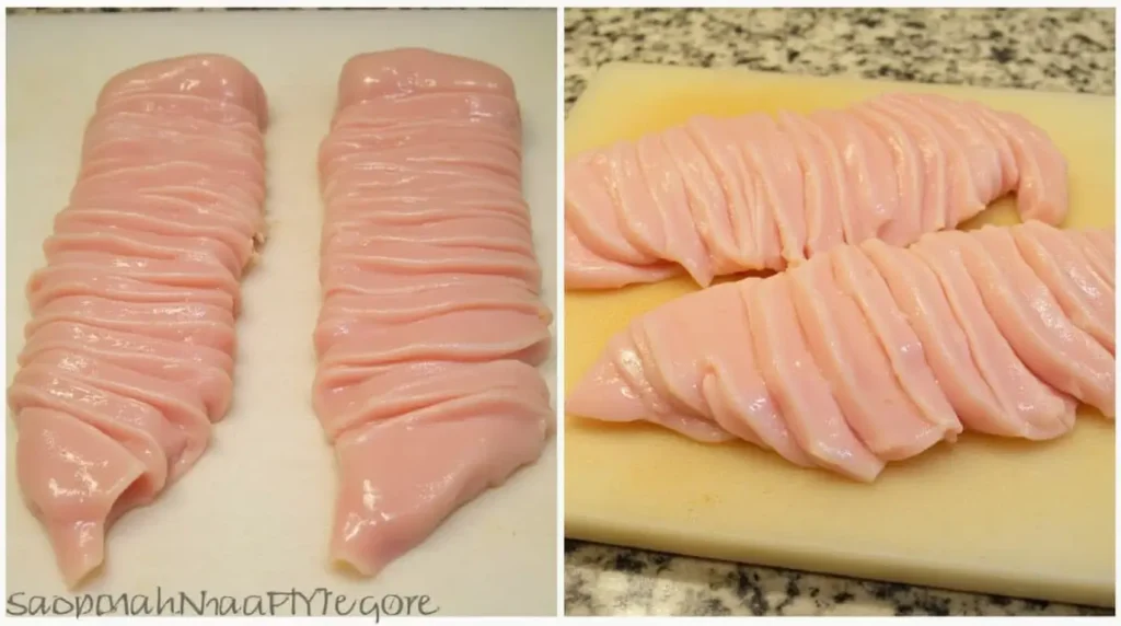 Professionally sliced chicken breasts on a cutting board, with precise, uniform cuts